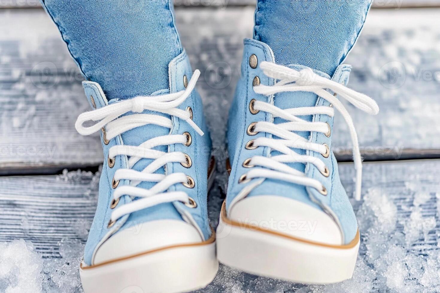 A person wearing blue jeans and white sneakers photo