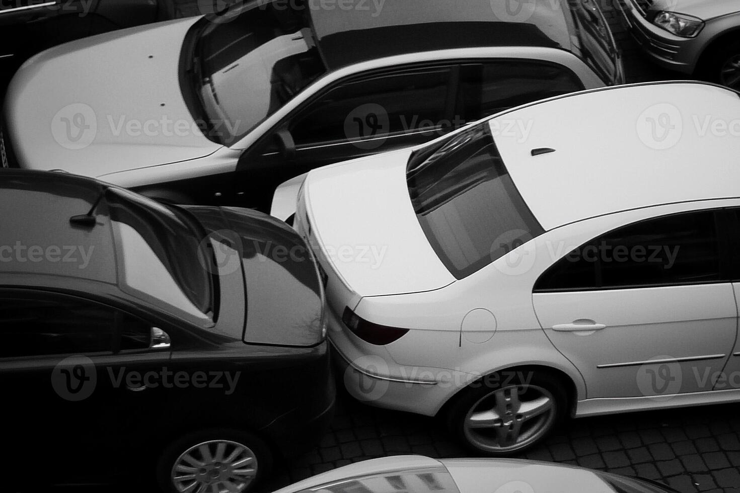 Black and white photo of cars parked in a parking lot
