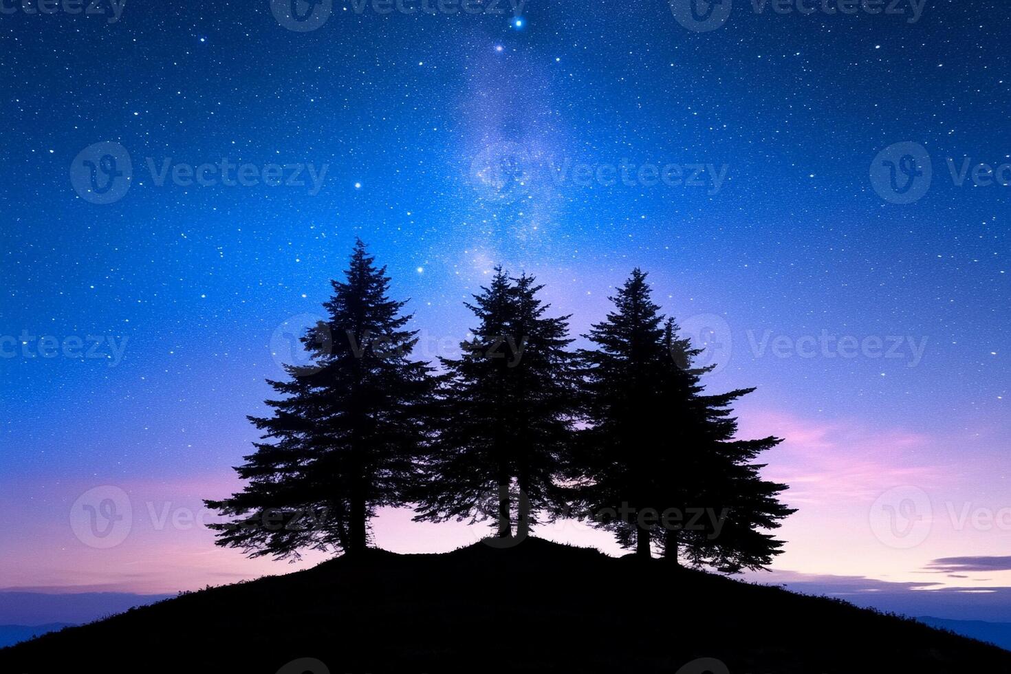 Three trees stand on a hill at night with the milky way in the background photo