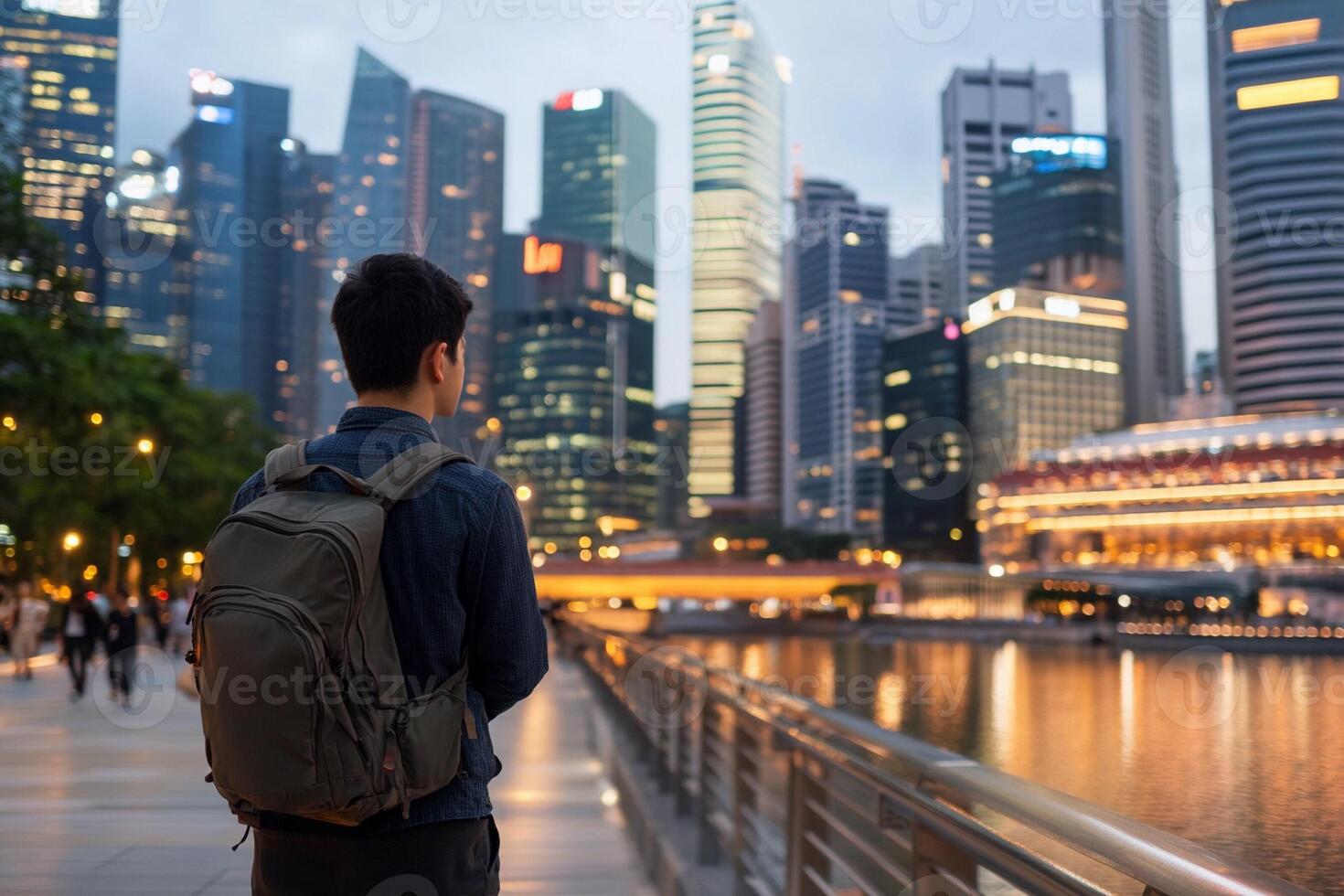 A man with a backpack standing in front of a city skyline photo