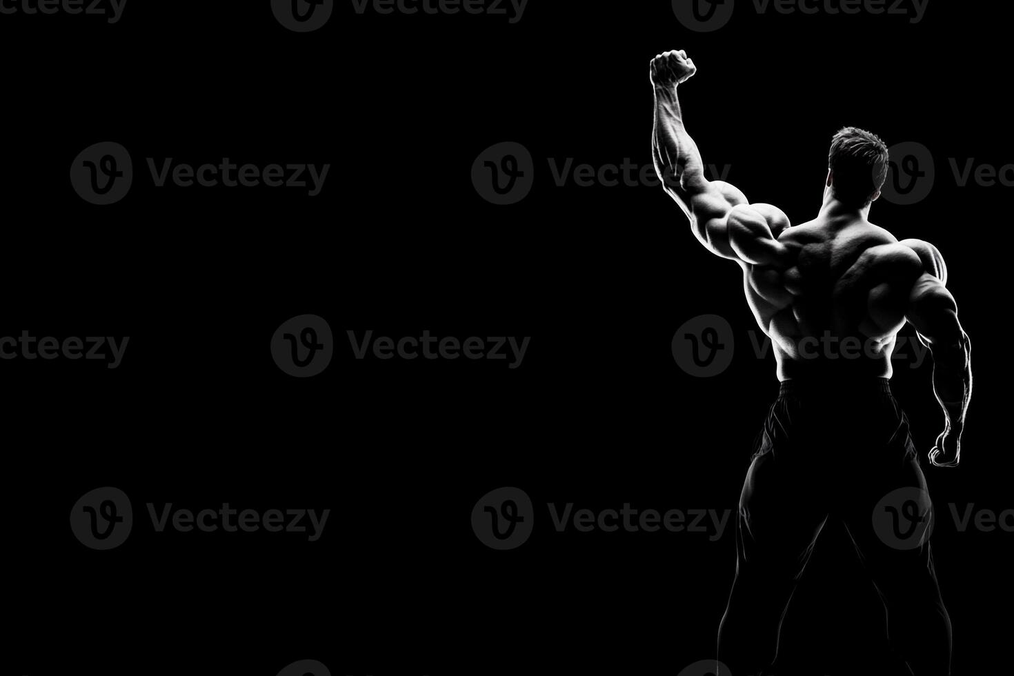 A man is standing in front of a black background photo