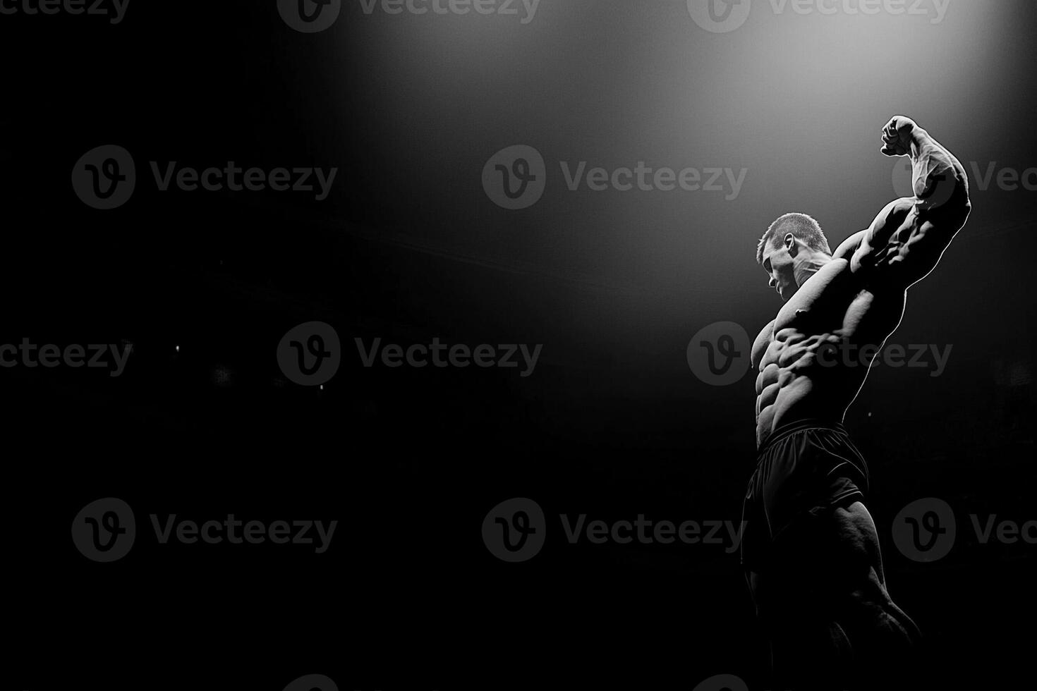 A man is standing in the dark with his arms out photo