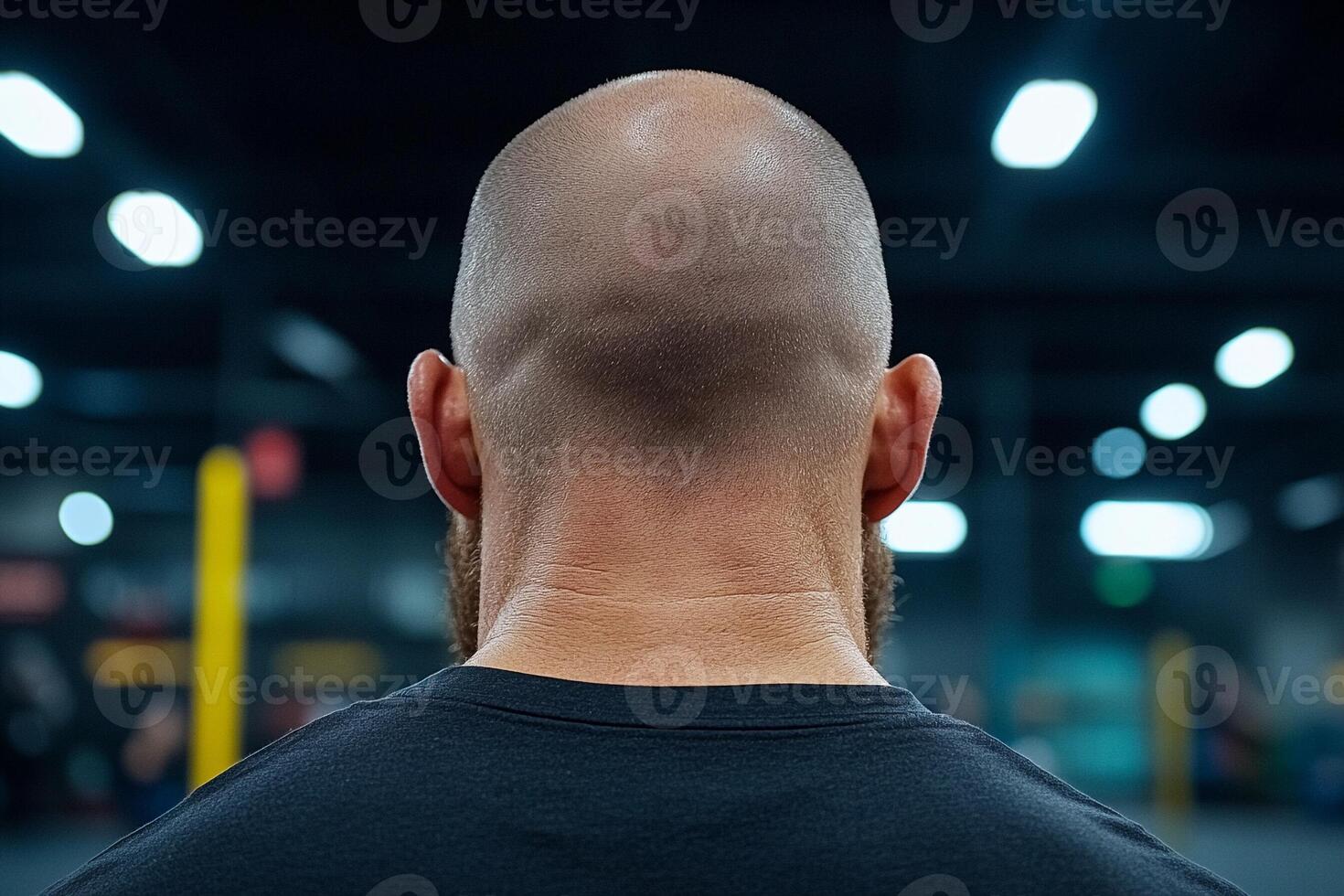 A bald man with a beard in a gym photo