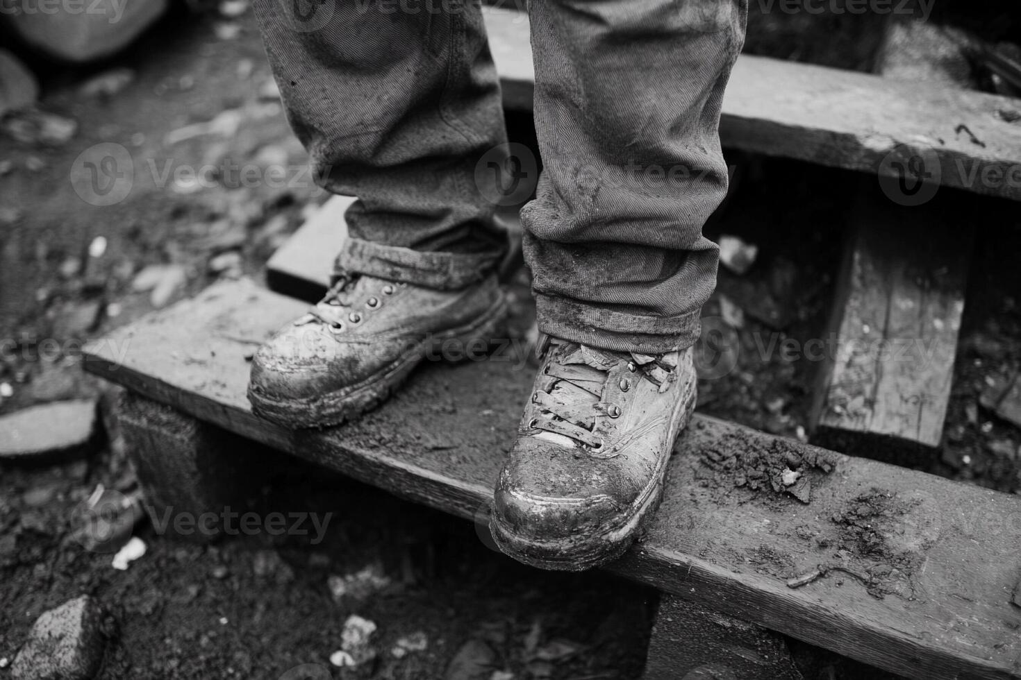 A person wearing dirty shoes standing on a wooden bench photo
