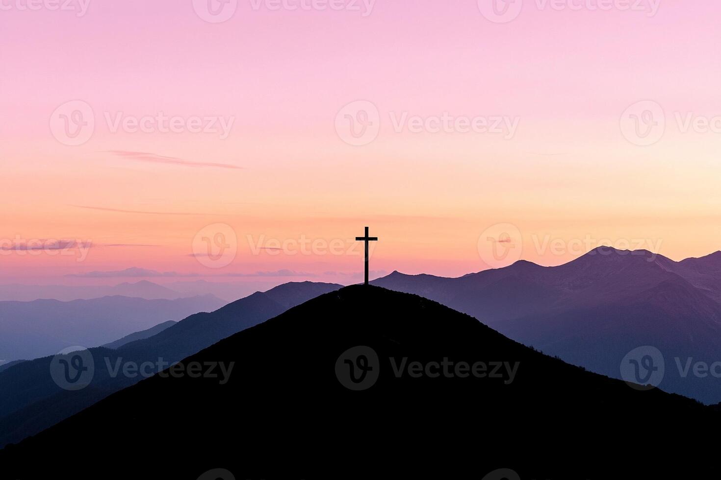 A cross on top of a mountain at sunset photo