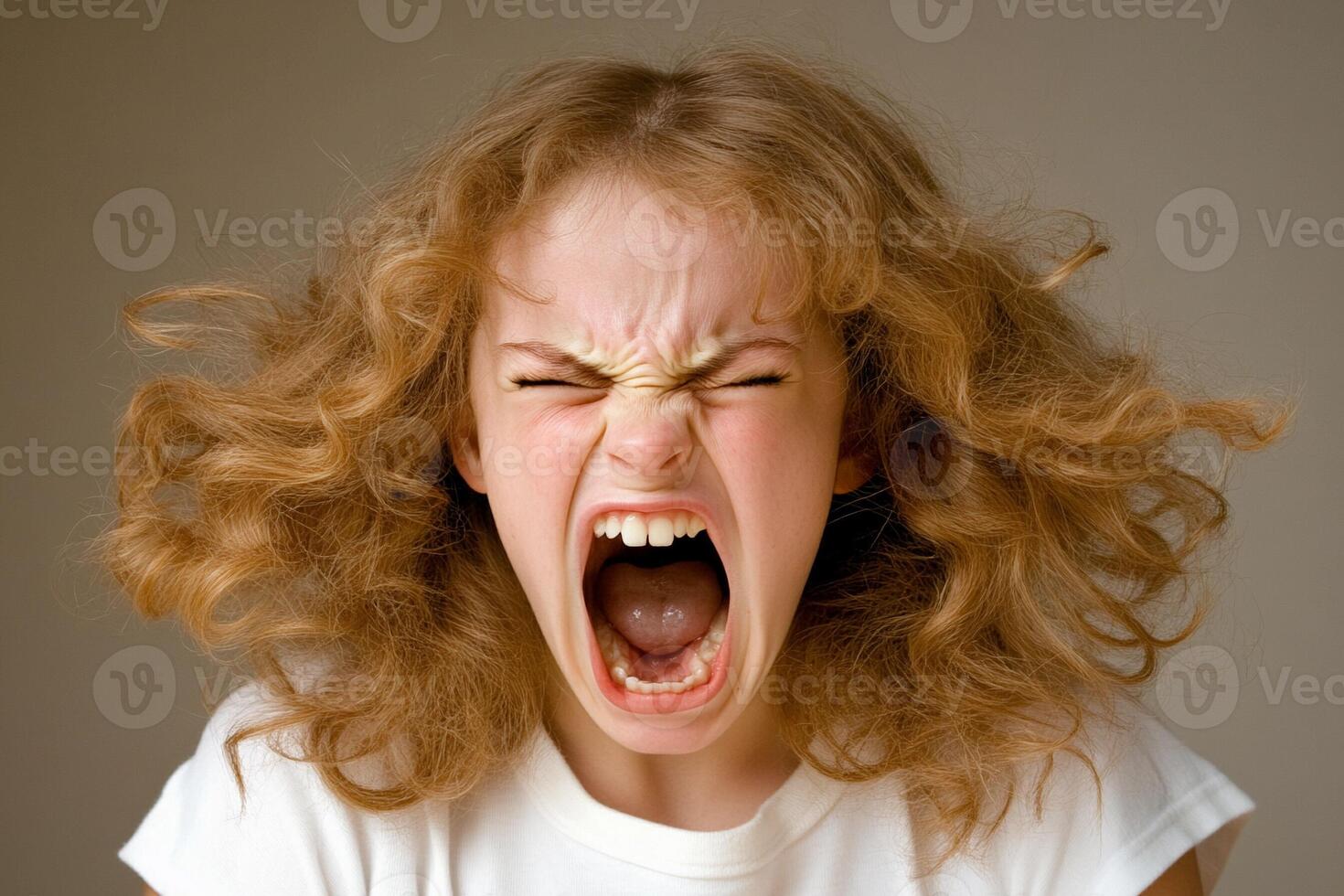 A young girl with her mouth open and her hair blowing in the wind photo