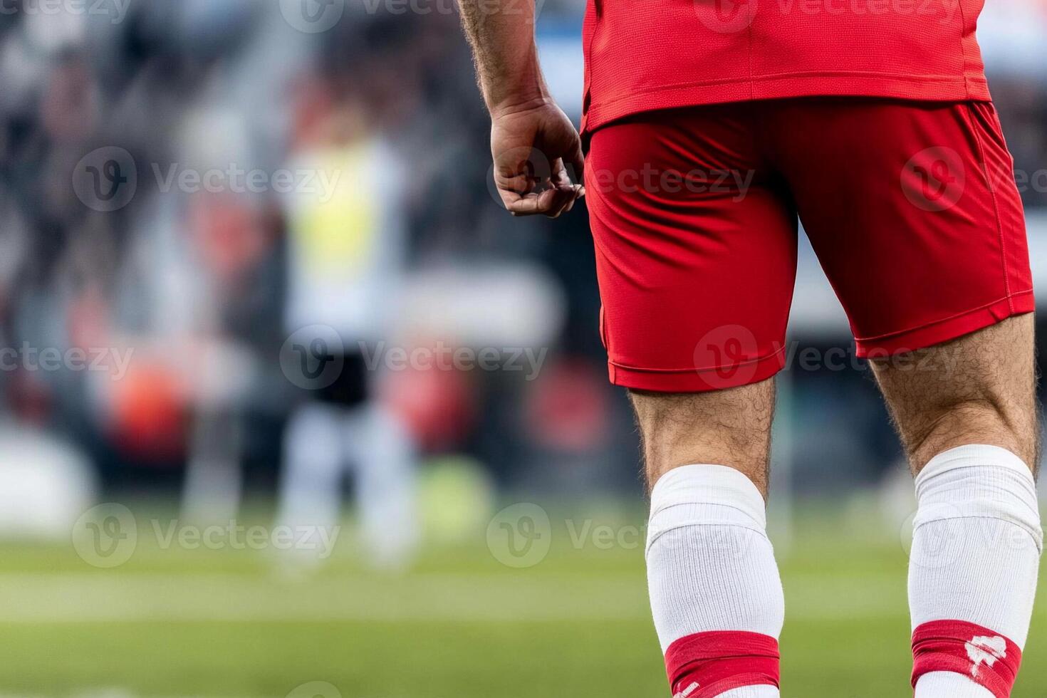 A soccer player in red shorts and white socks photo