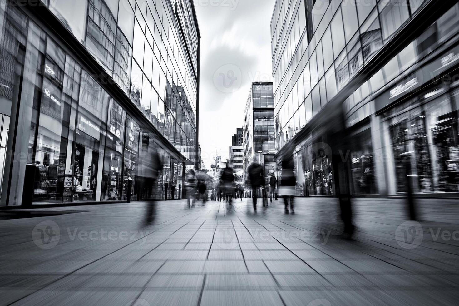 Black and white image of people walking down a street photo