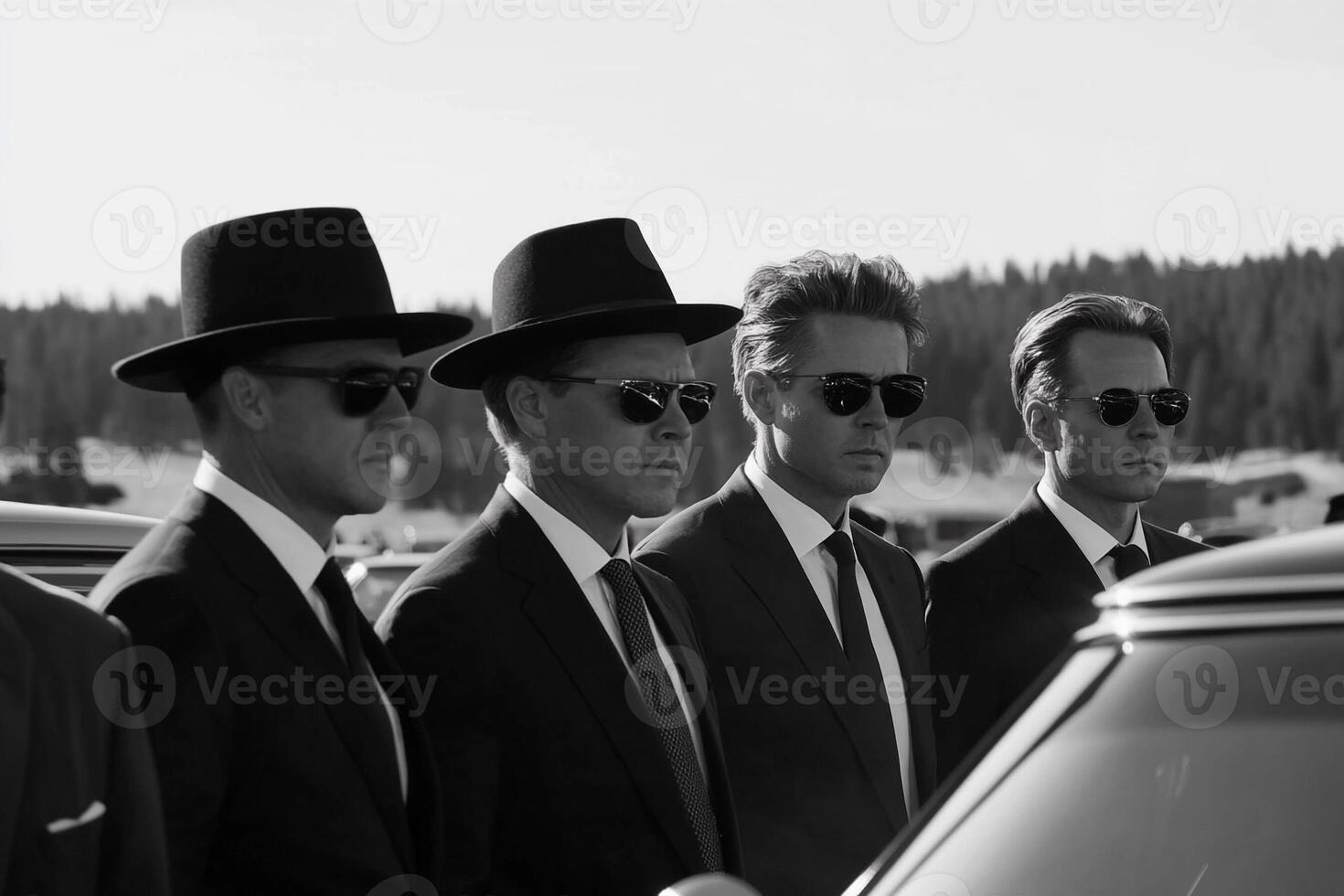 Men in suits and hats standing next to a car photo
