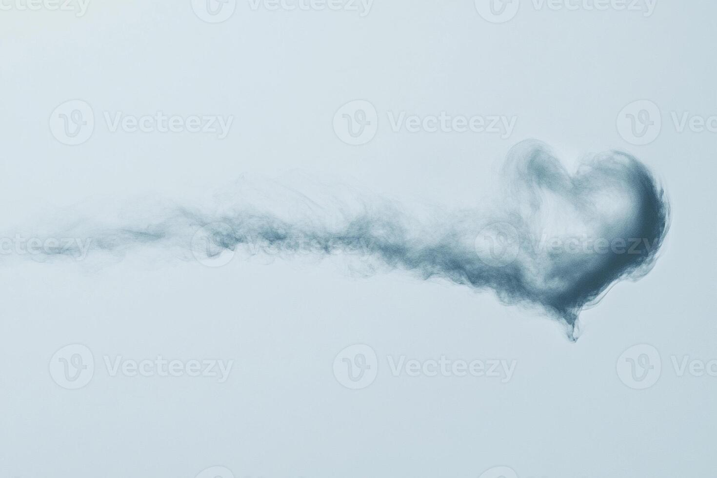 A heart shaped cloud of smoke is blowing in the air photo