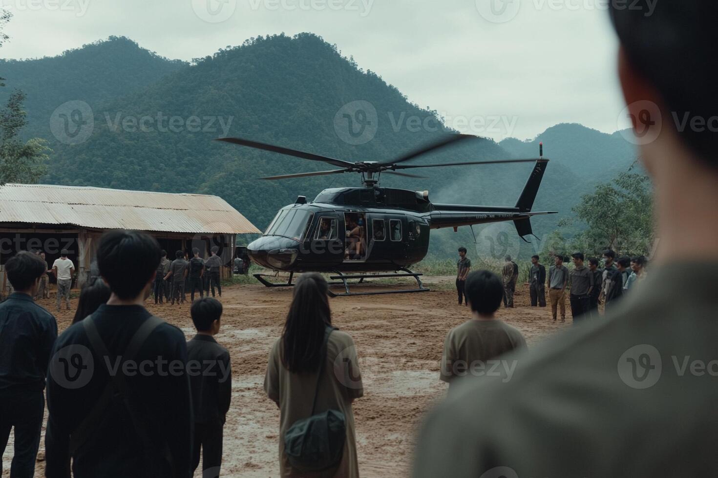 A group of people standing around a helicopter in front of a mountain photo