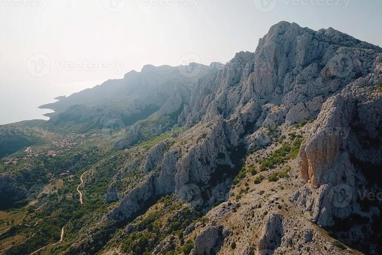 The view from the top of a mountain overlooking the sea photo