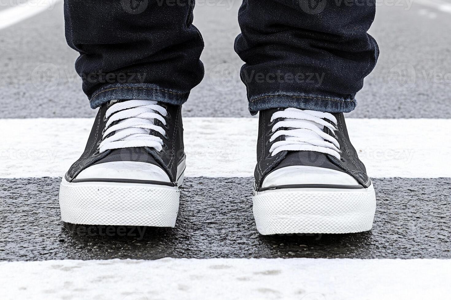 A person wearing black and white sneakers photo