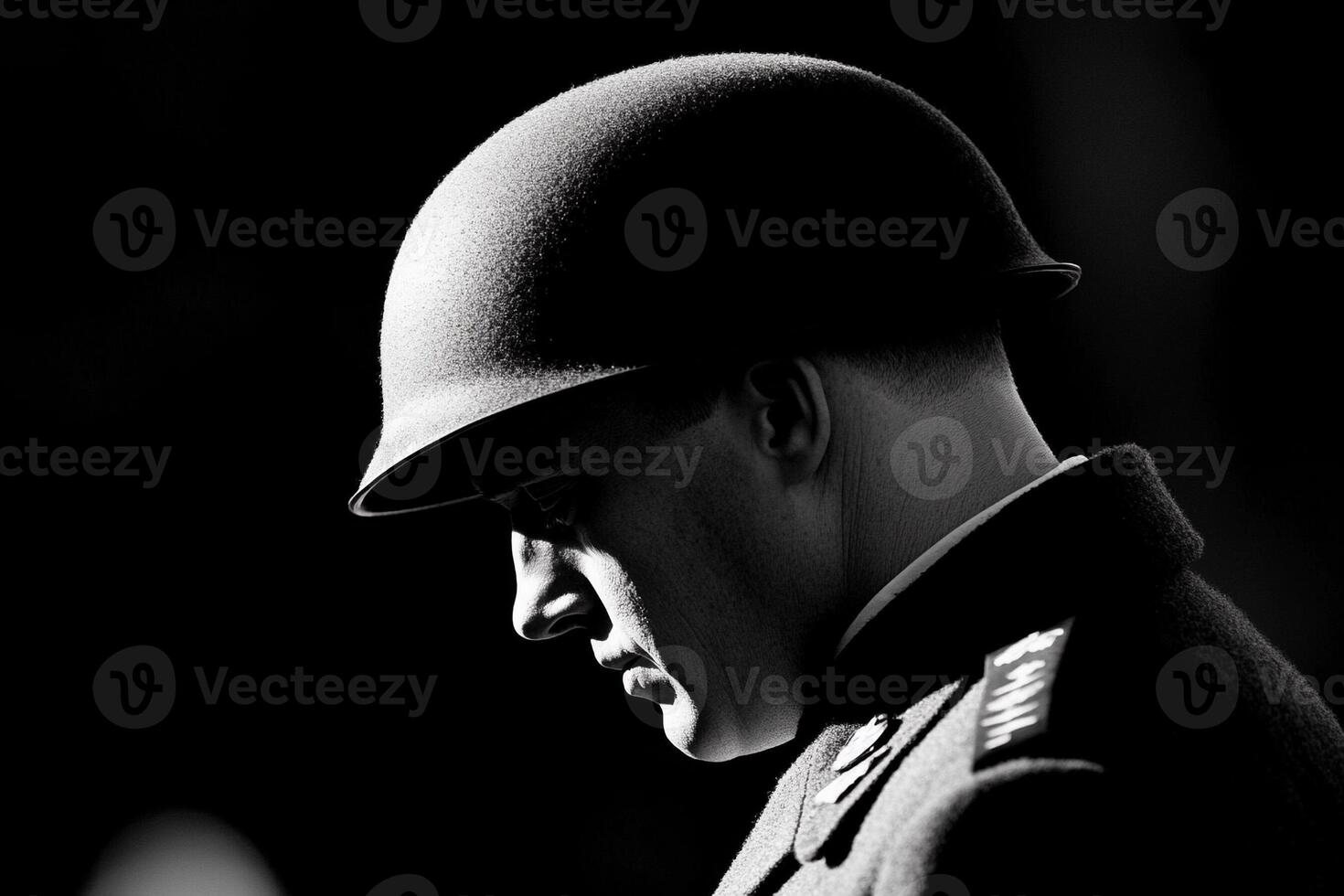 A man in uniform is looking down photo