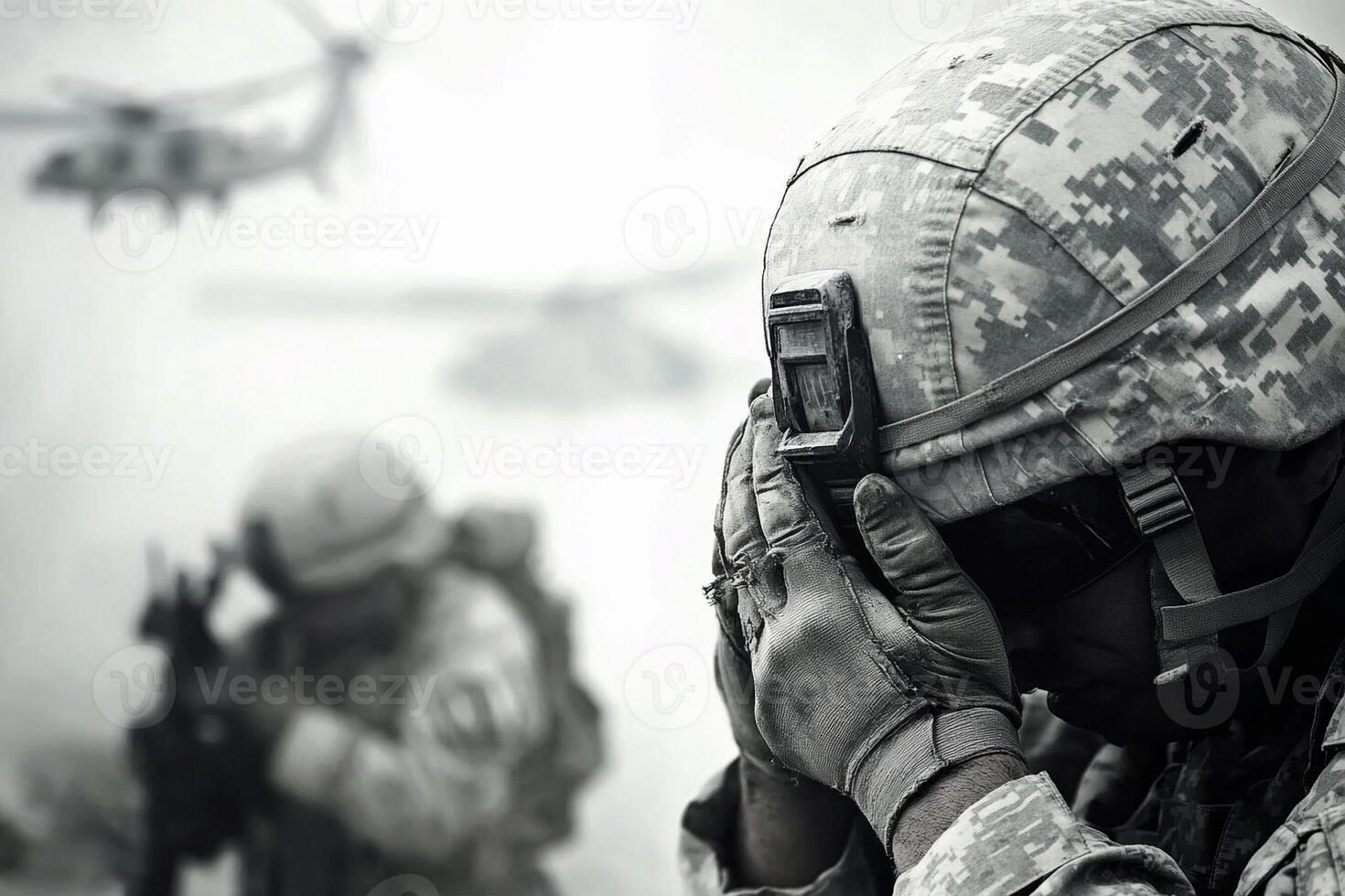 A soldier is holding his head in his hands photo