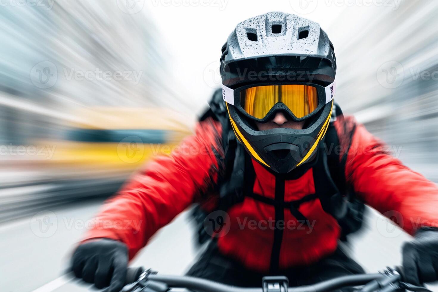 A man in a helmet and goggles riding a bike photo