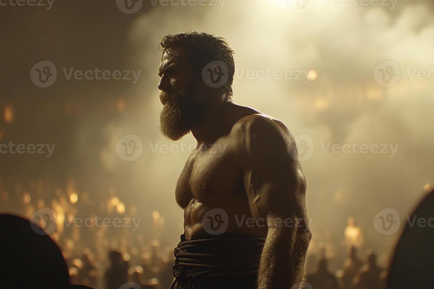 A shirtless man with a beard standing in front of a crowd photo