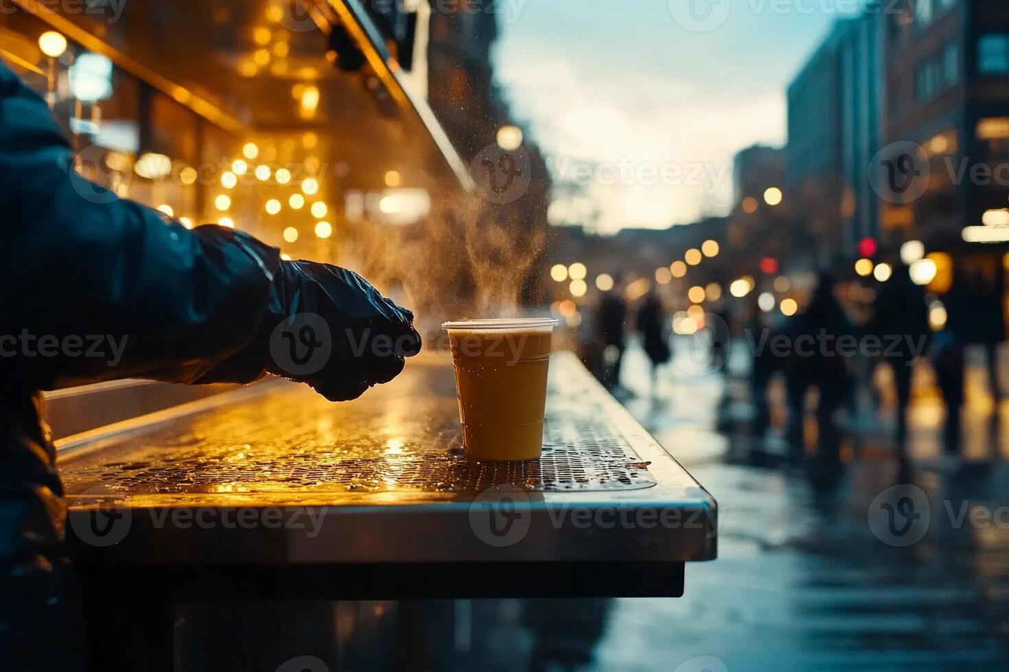 A person holding a cup of coffee on a street photo