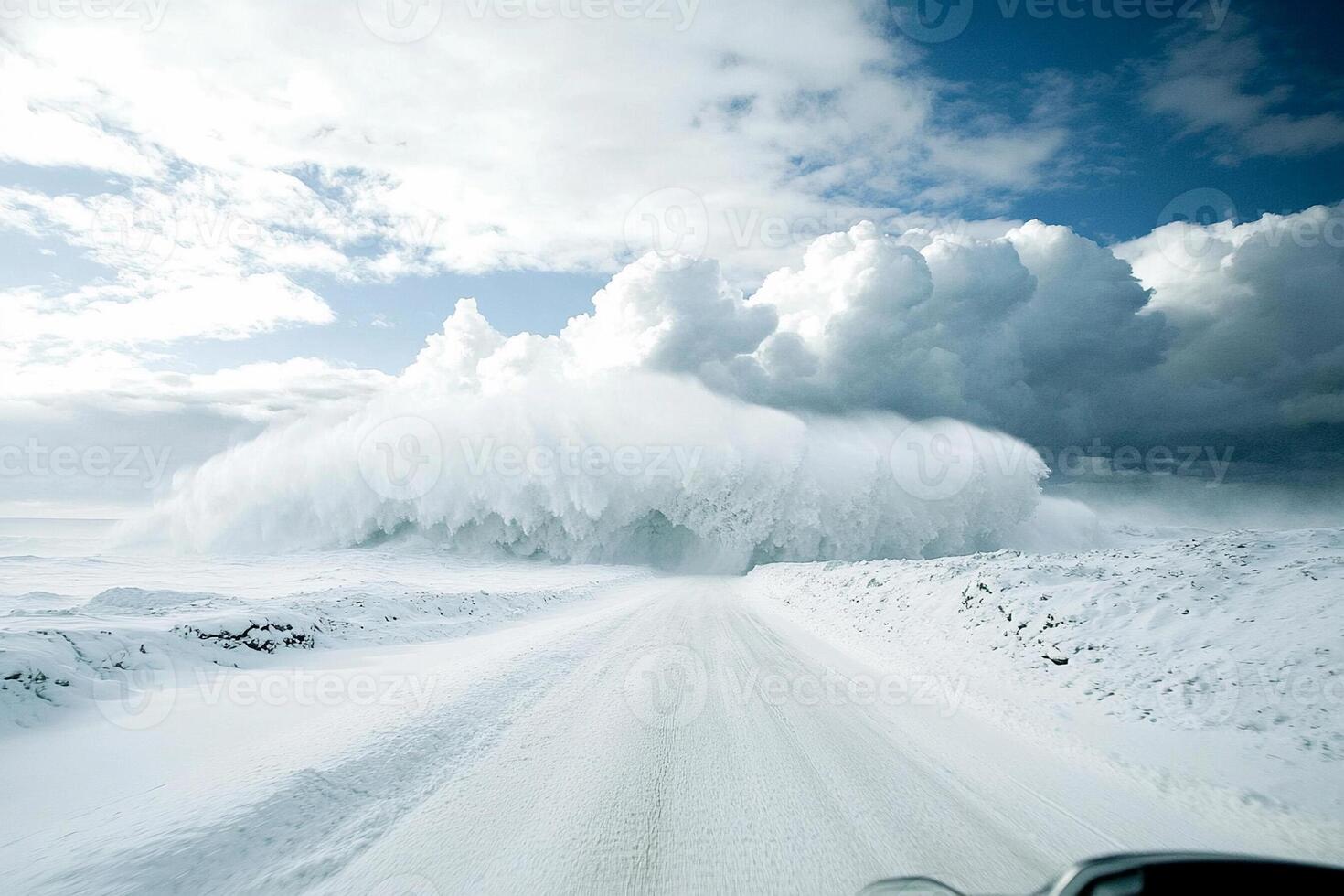 A car driving through a snow covered road photo