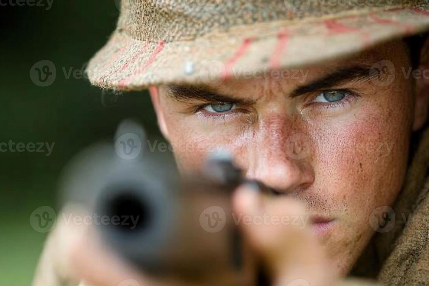 A man in a hat is aiming at something photo