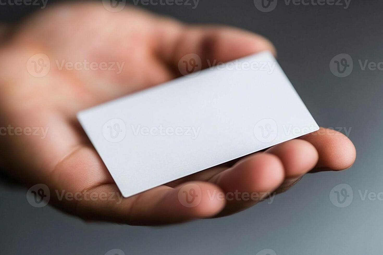 A person holding a blank business card photo