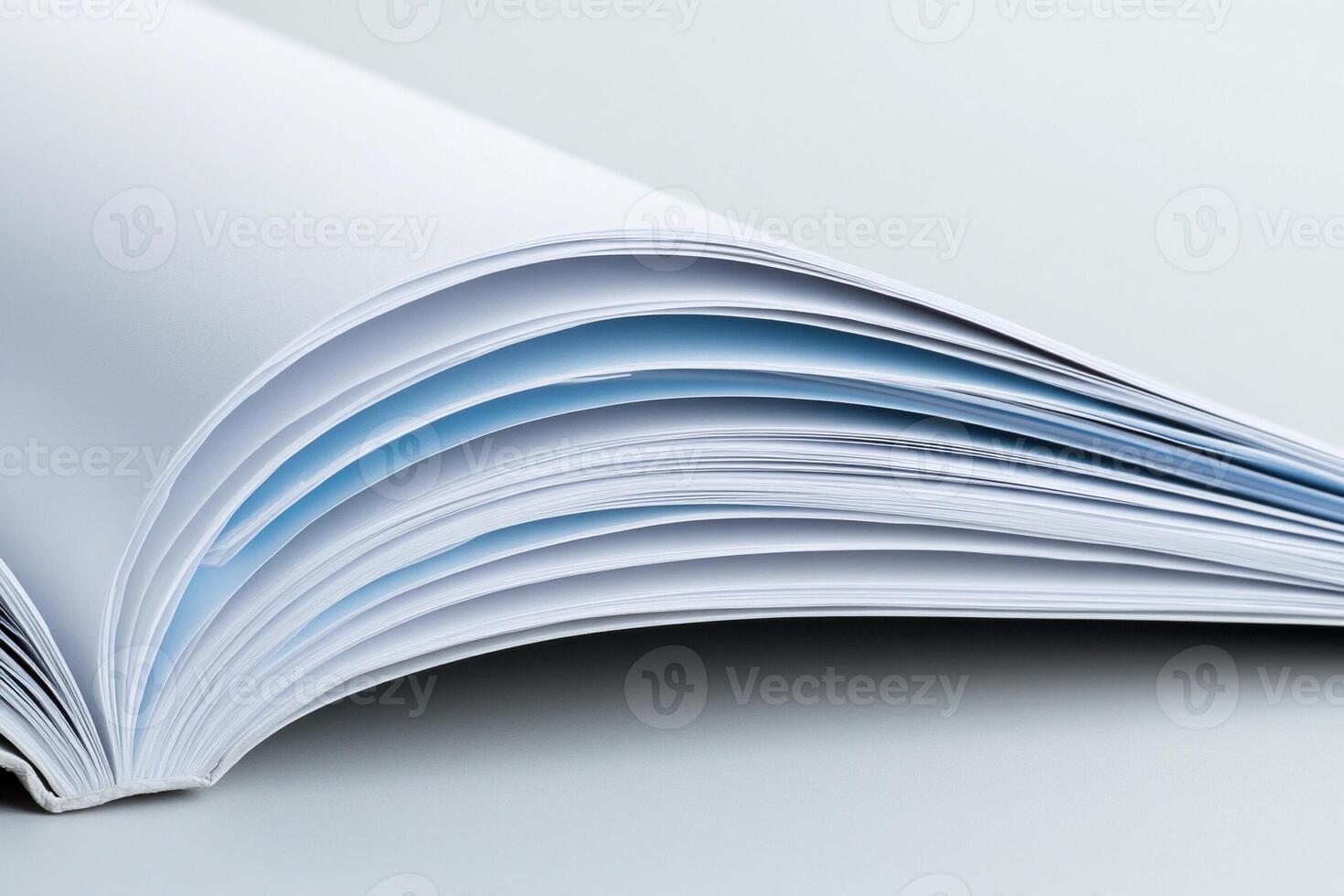 An open book with blue pages on a white background photo