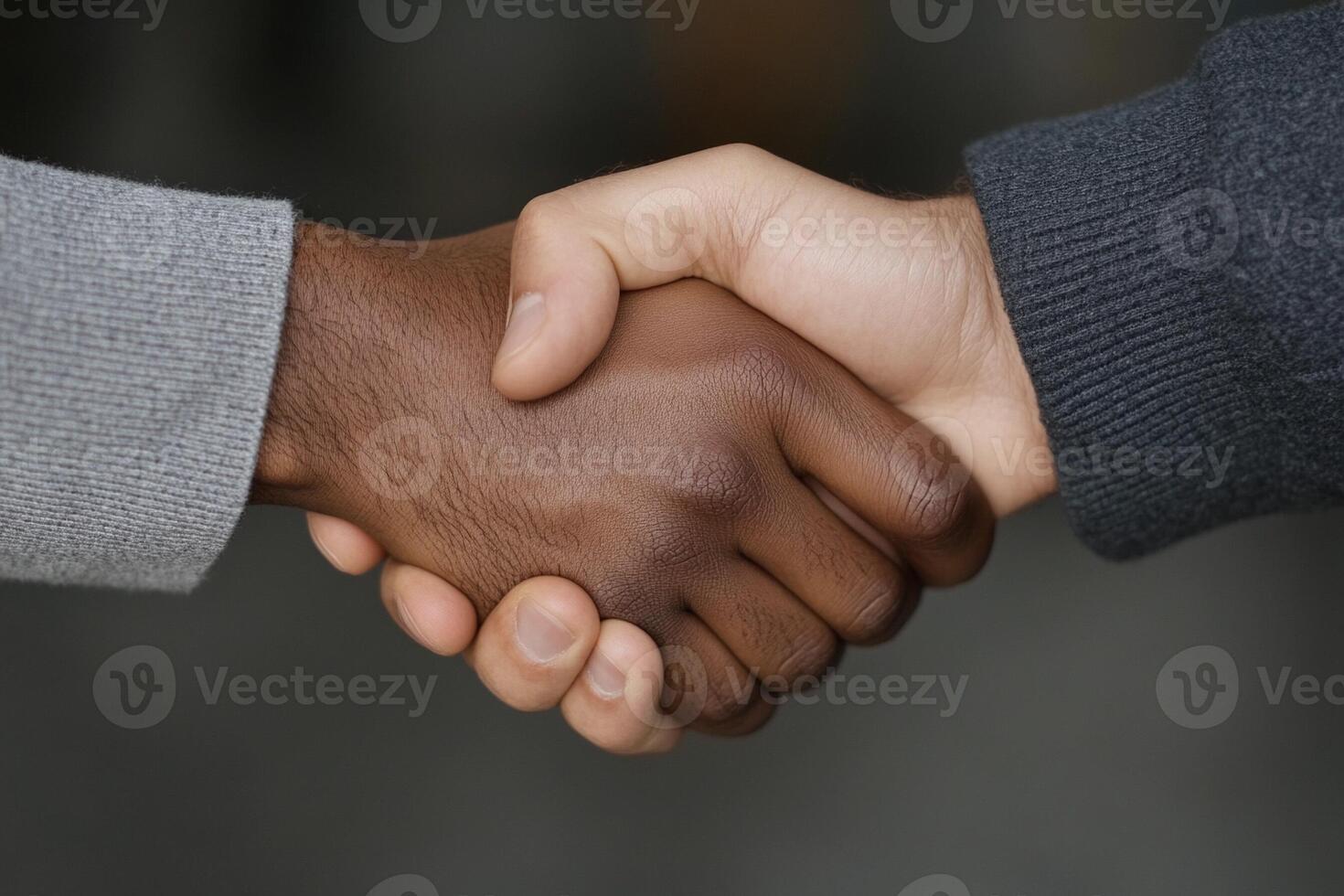 Two people shaking hands with each other photo