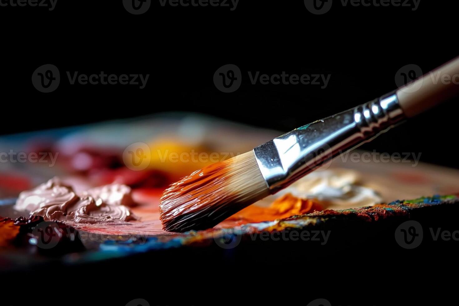 A paint brush is being used to paint on a palette photo