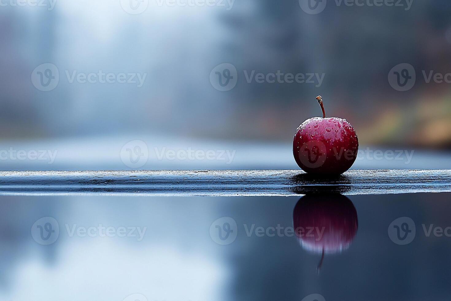 A red apple is sitting on a wooden ledge photo