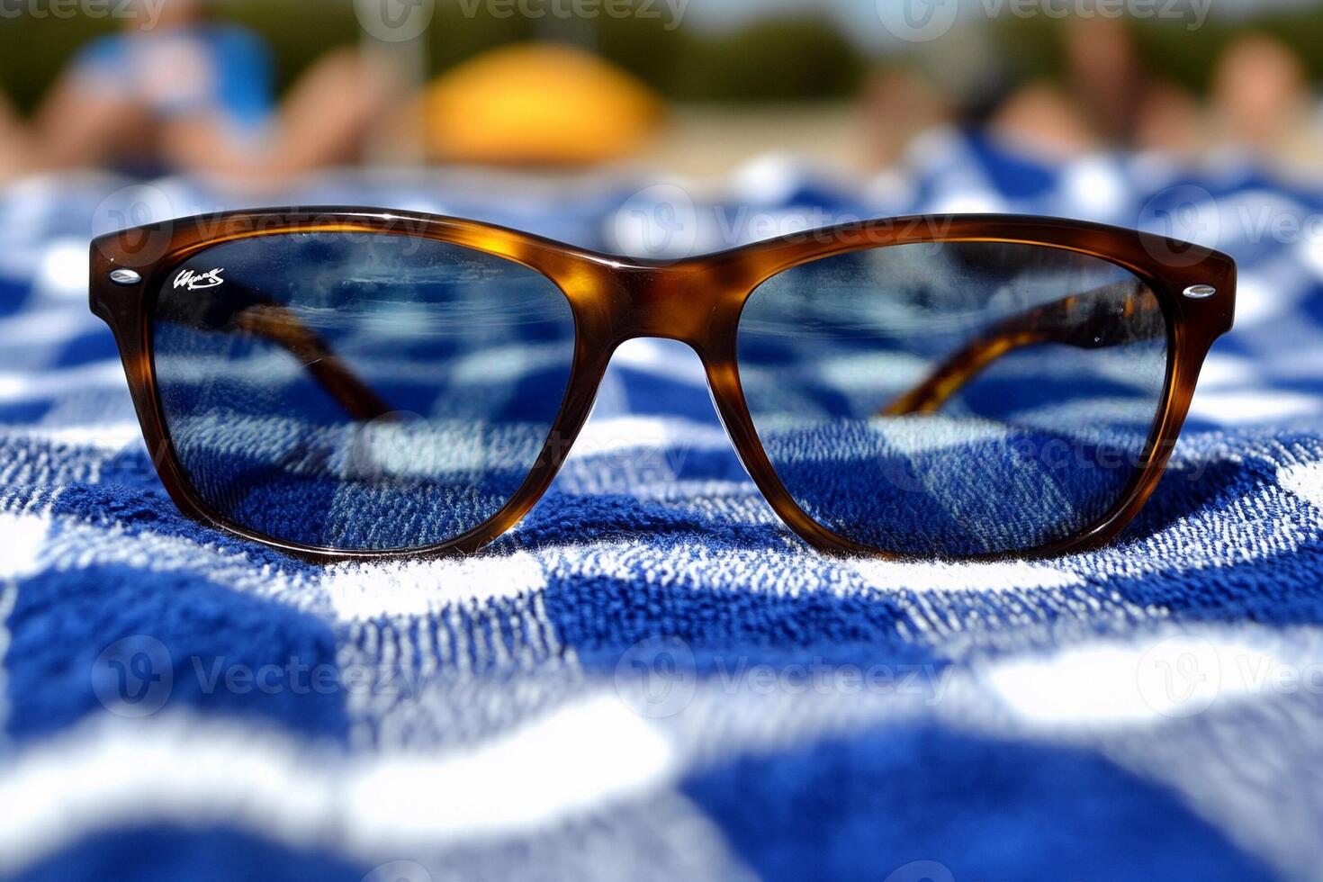 Ray ban sunglasses on a beach towel photo