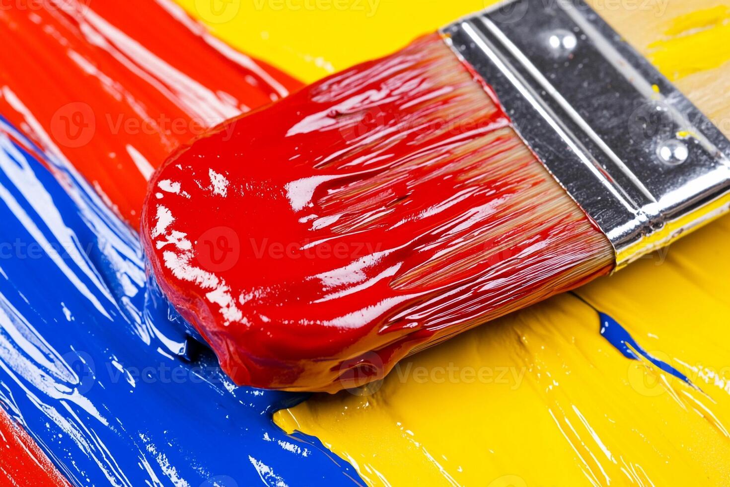 A paint brush is sitting on a colorful paint photo