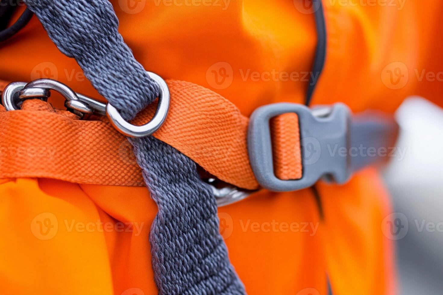 A person wearing an orange jacket and a belt photo