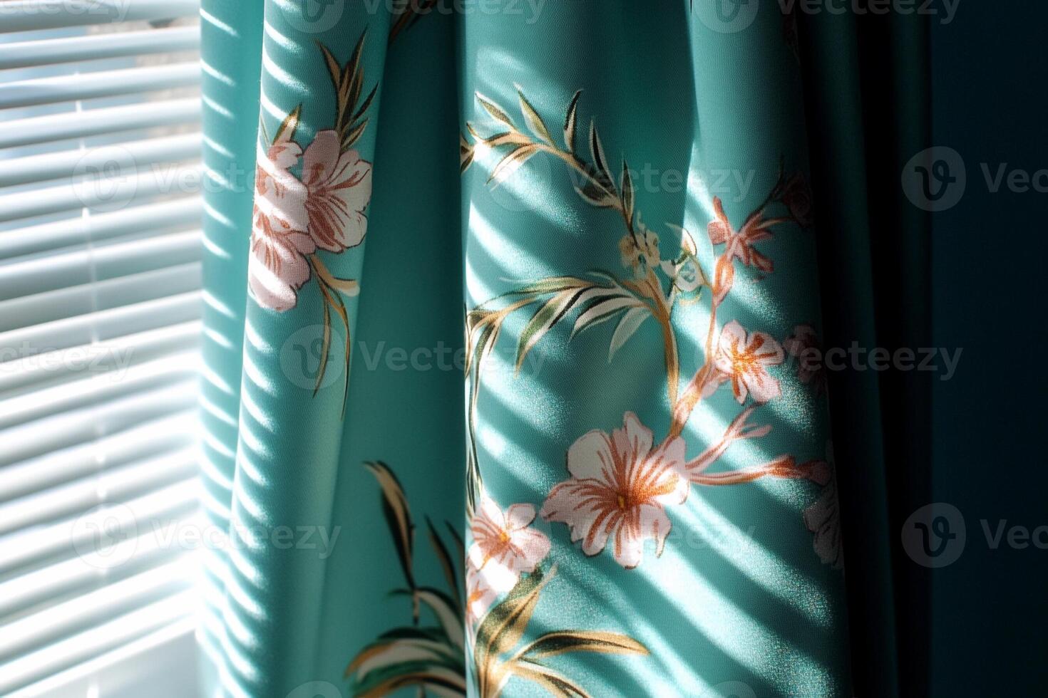 A window with blinds and a floral curtain photo