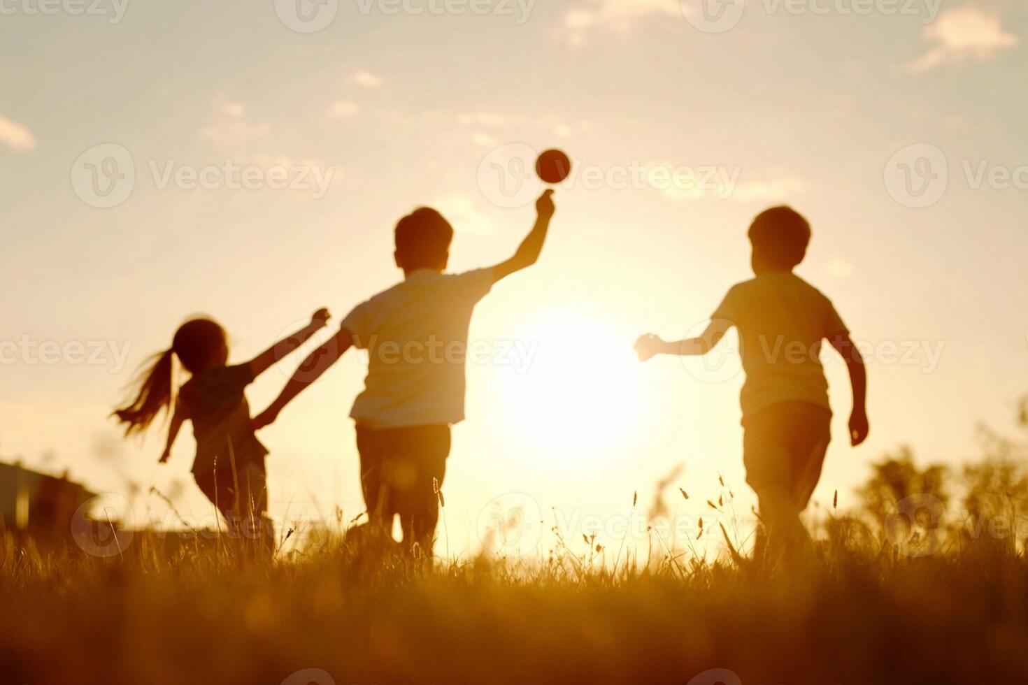 Three children playing with a ball in a field photo