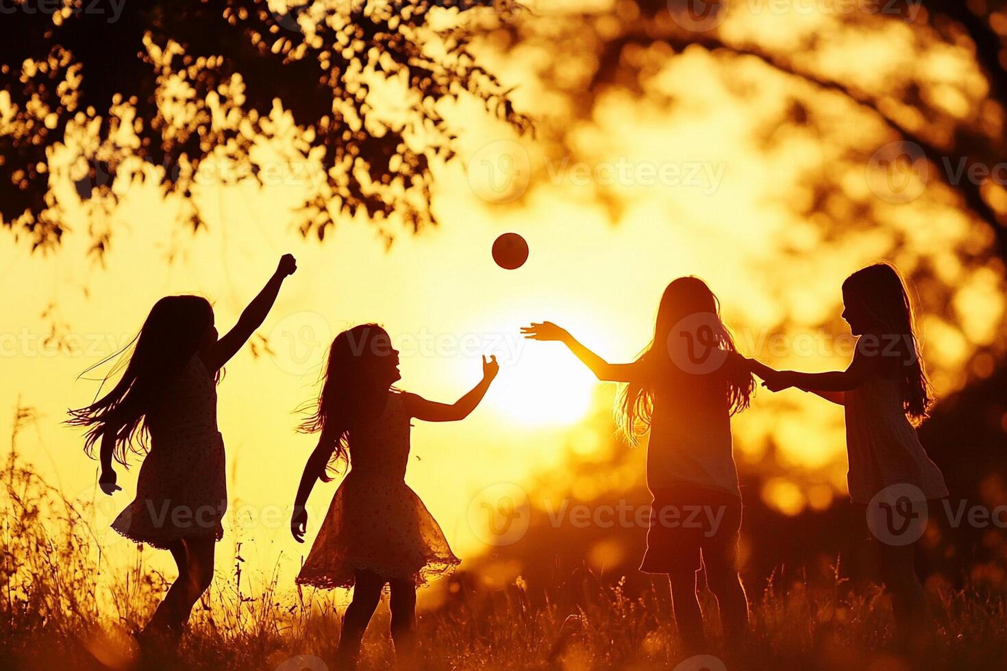 Silhouette of children playing with a ball in the sunset photo