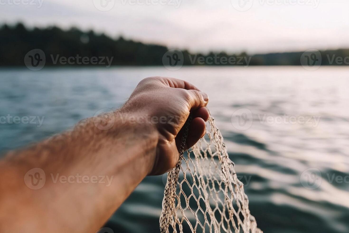 A person holding a net over the water photo