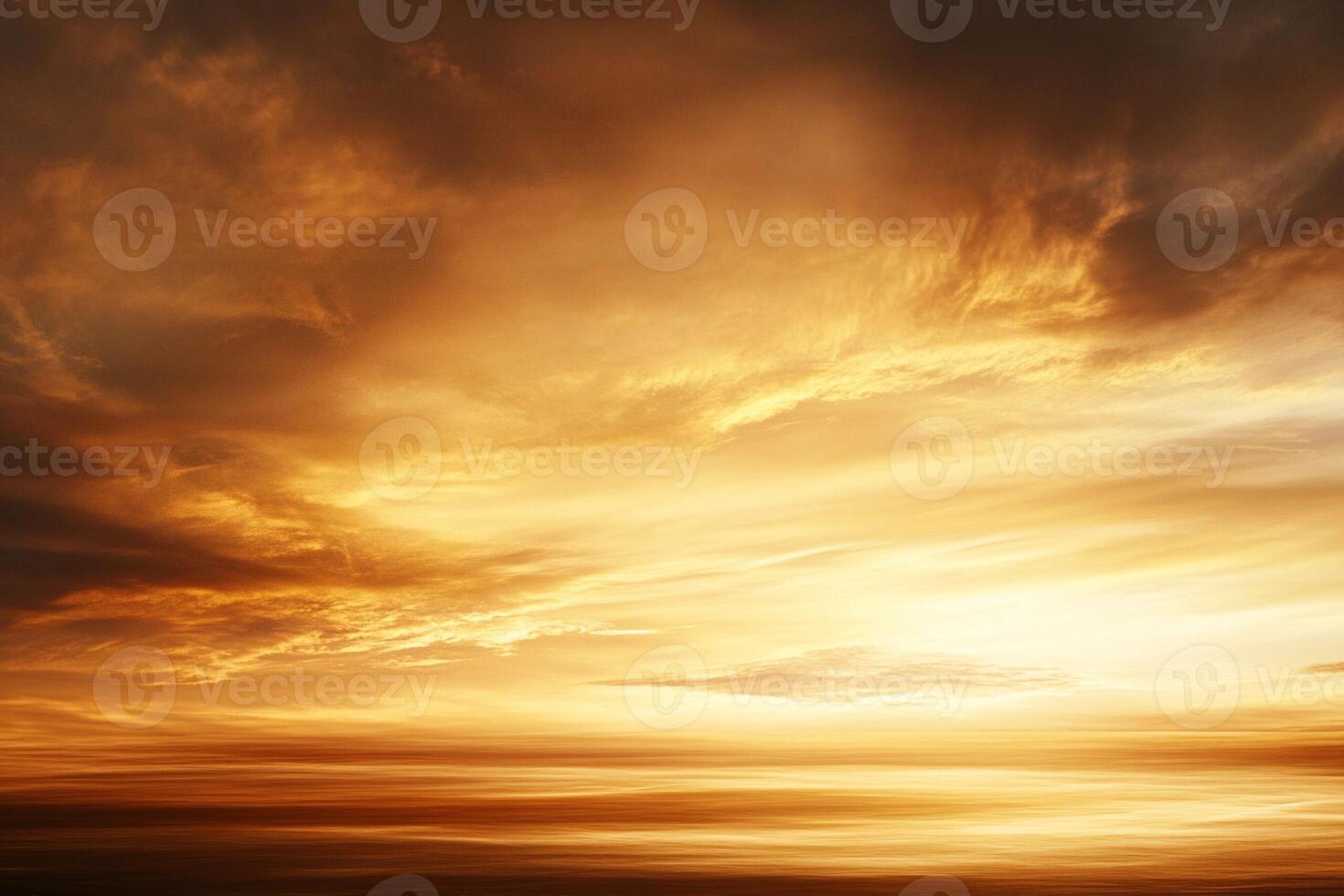 A sunset over the ocean with clouds photo