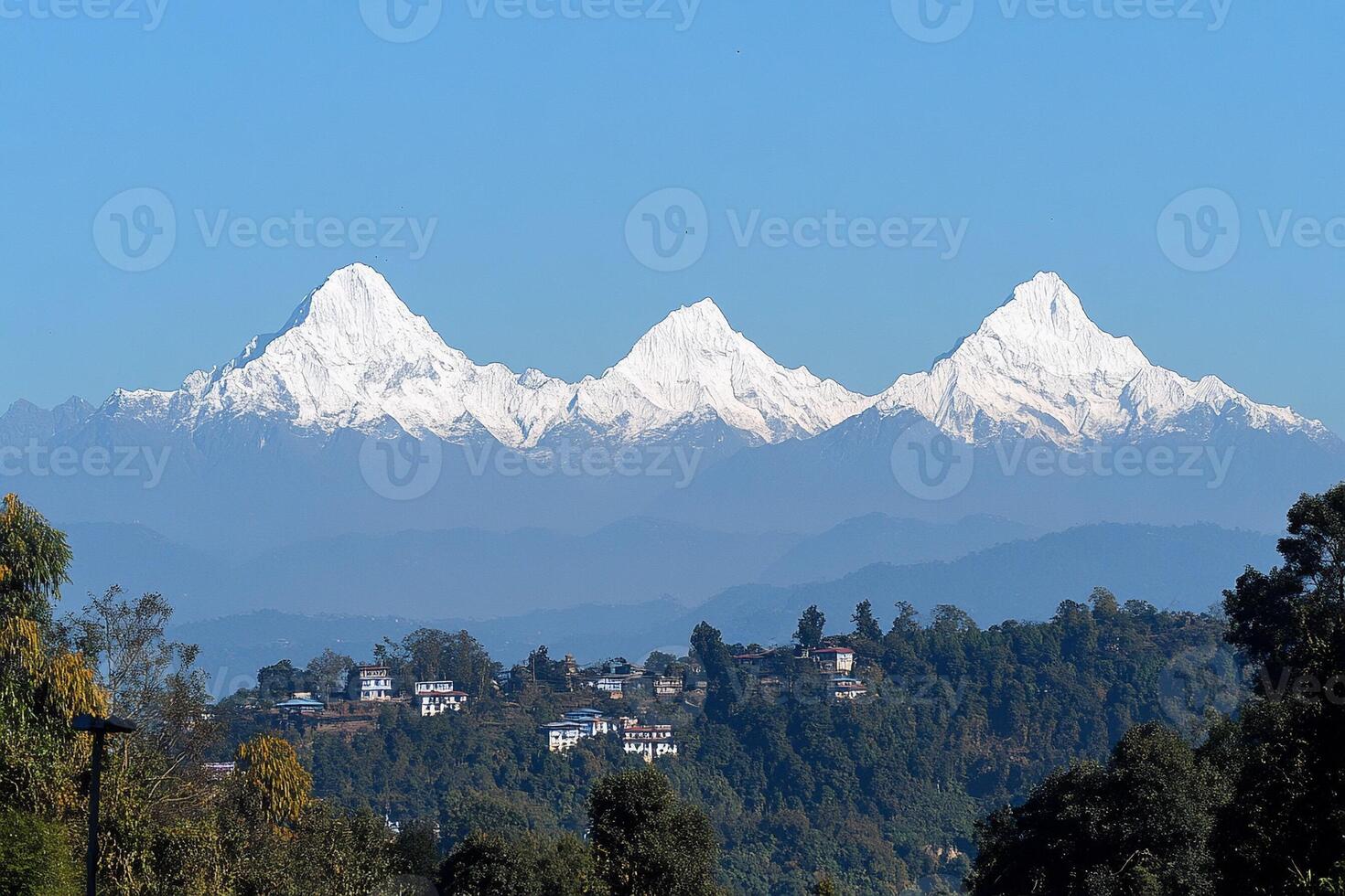 The snow capped mountains are seen from a distance photo