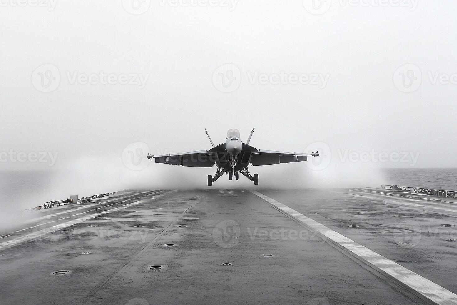 A fighter jet taking off from the deck of an aircraft carrier photo