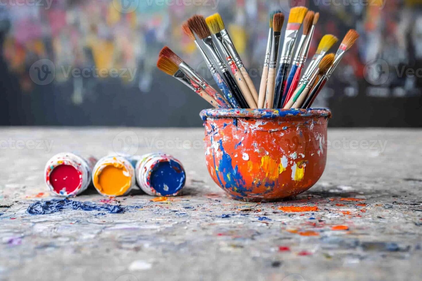 Paint brushes and paint in a pot on a table photo