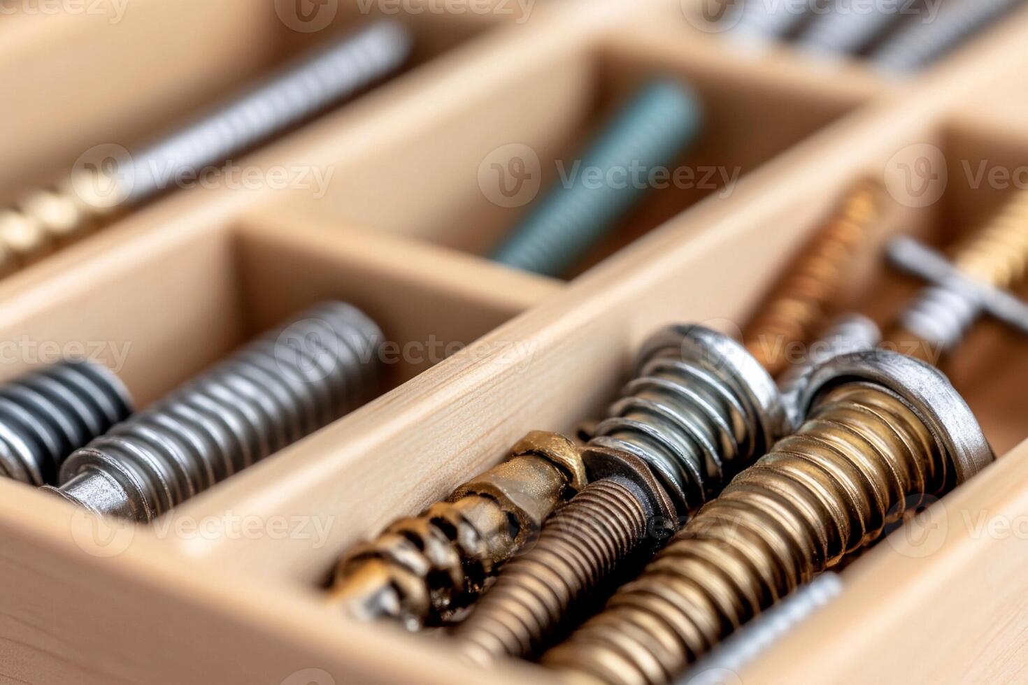 A wooden box with many different types of screws photo