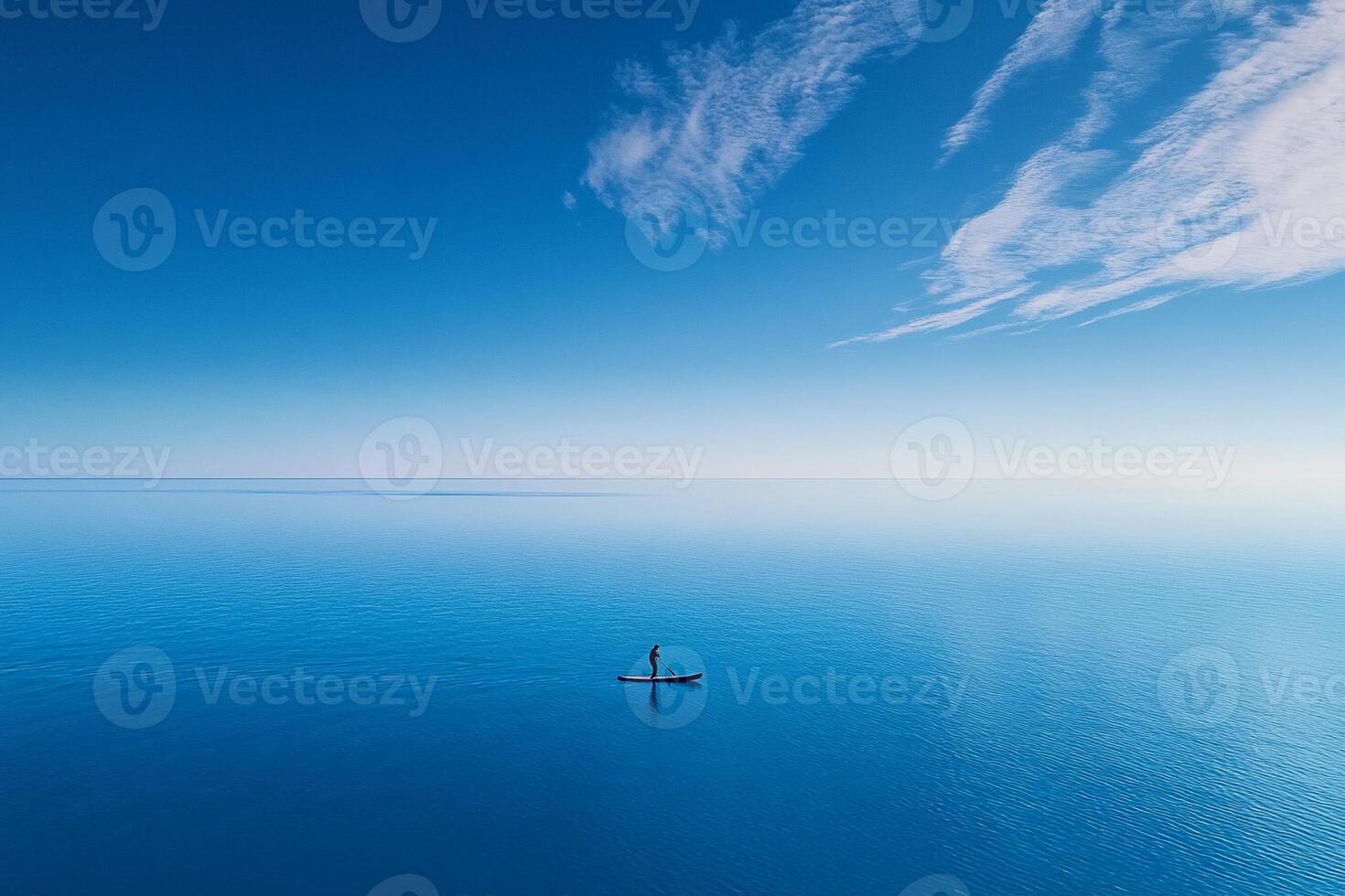 A person on a paddle board in the ocean photo