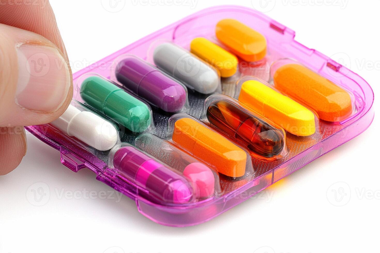 A person is holding a small plastic container with pills in it photo