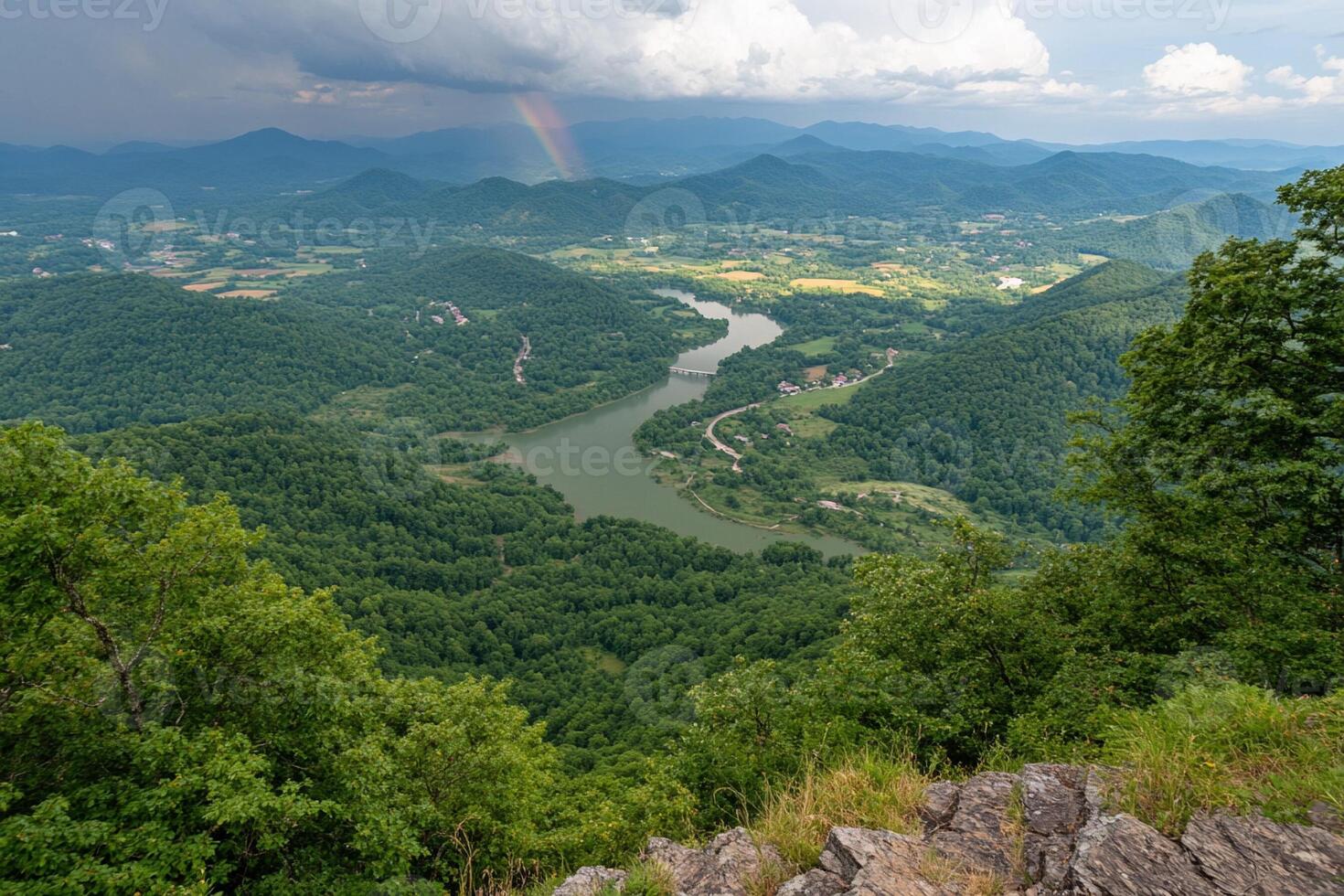 A view of a river and mountains from a mountain top photo