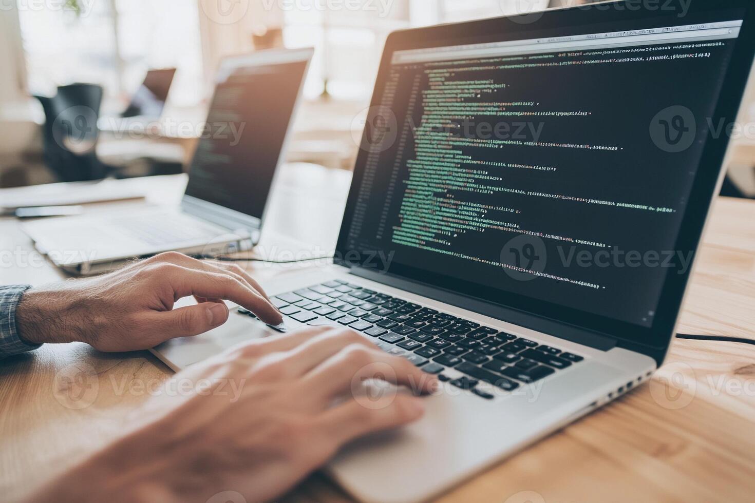 A person typing on a laptop computer with code on it photo
