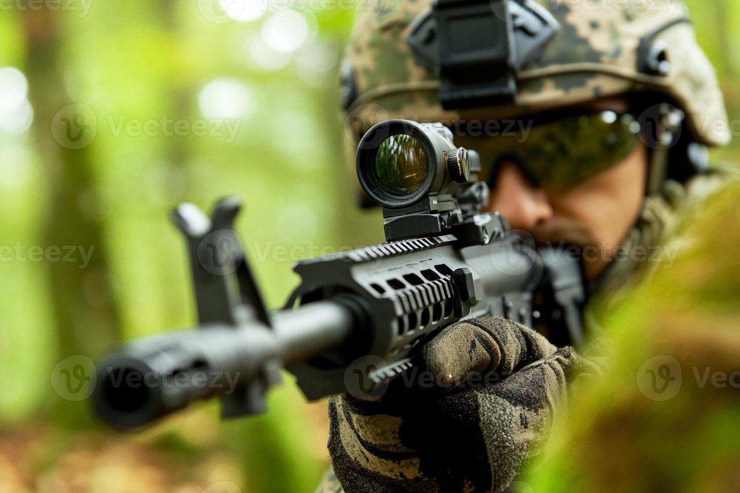 A soldier with a rifle in the woods photo
