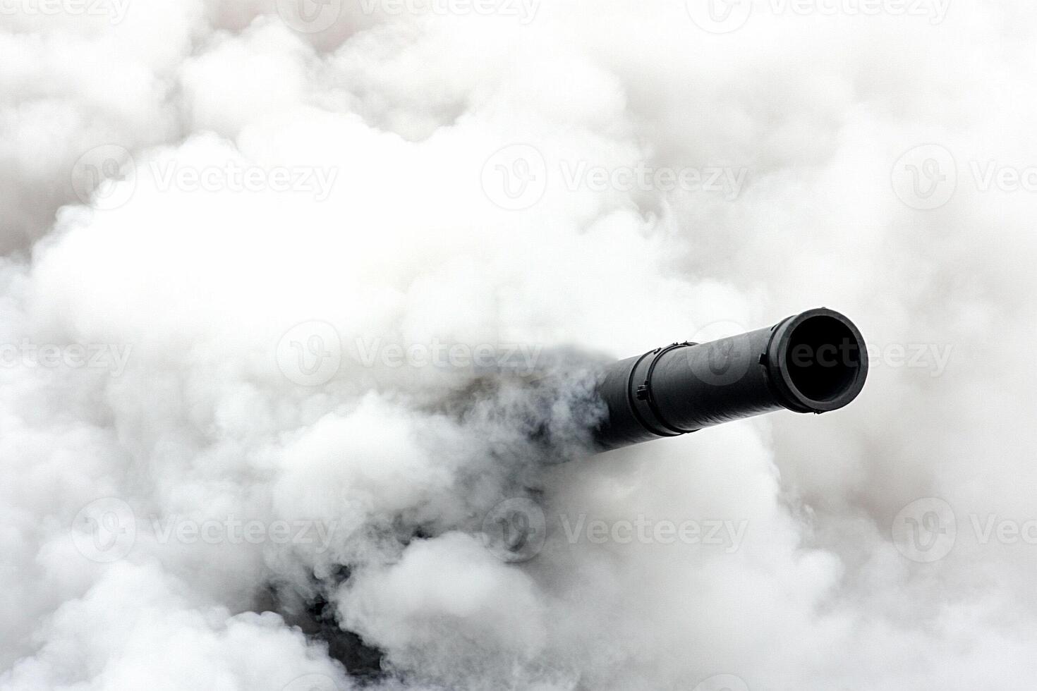 A black and white image of a cannon in the smoke photo