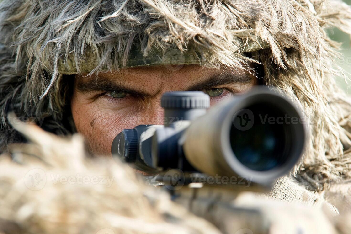 A man in camouflage is looking through a scope photo