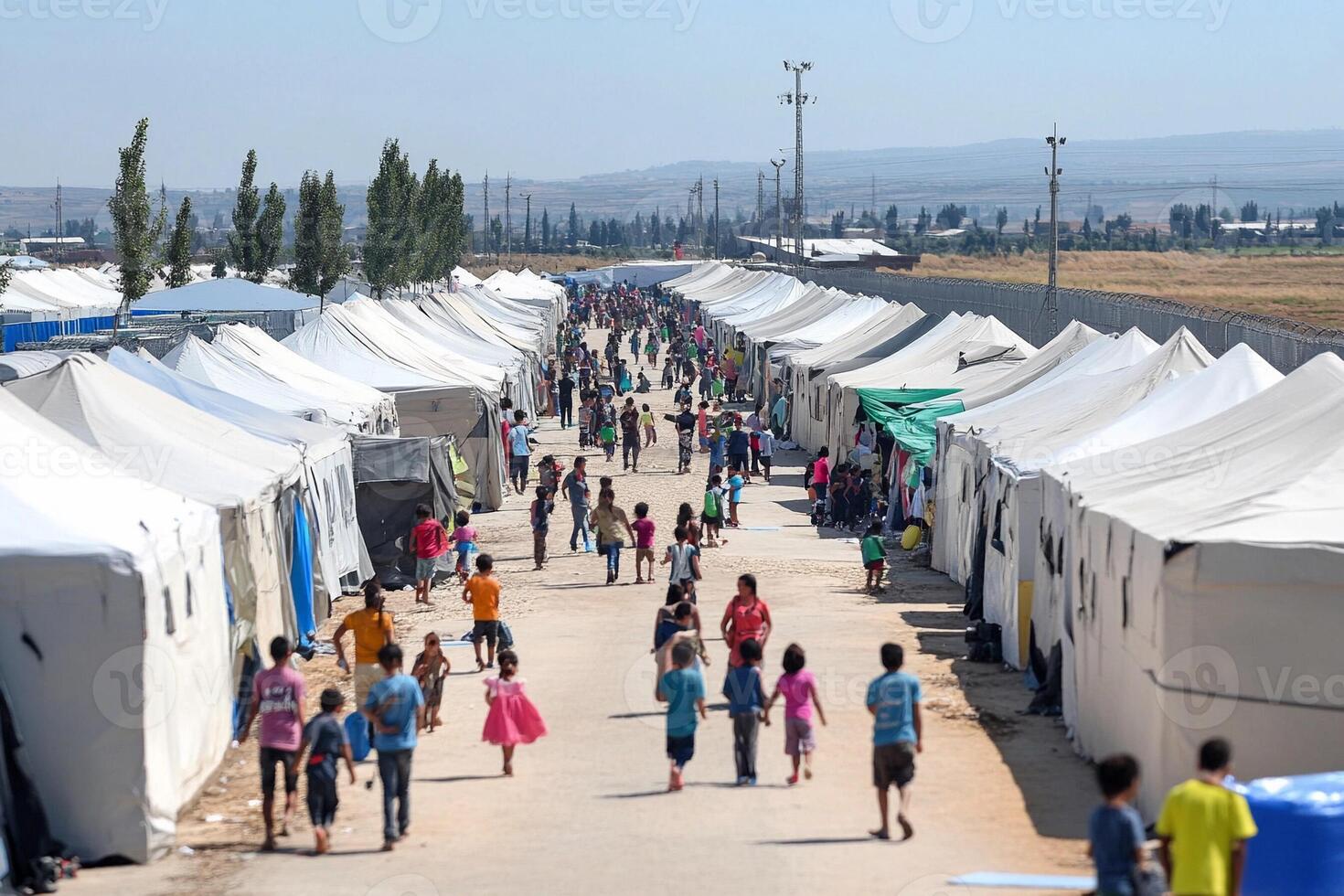 A group of people walking through tents in a field photo