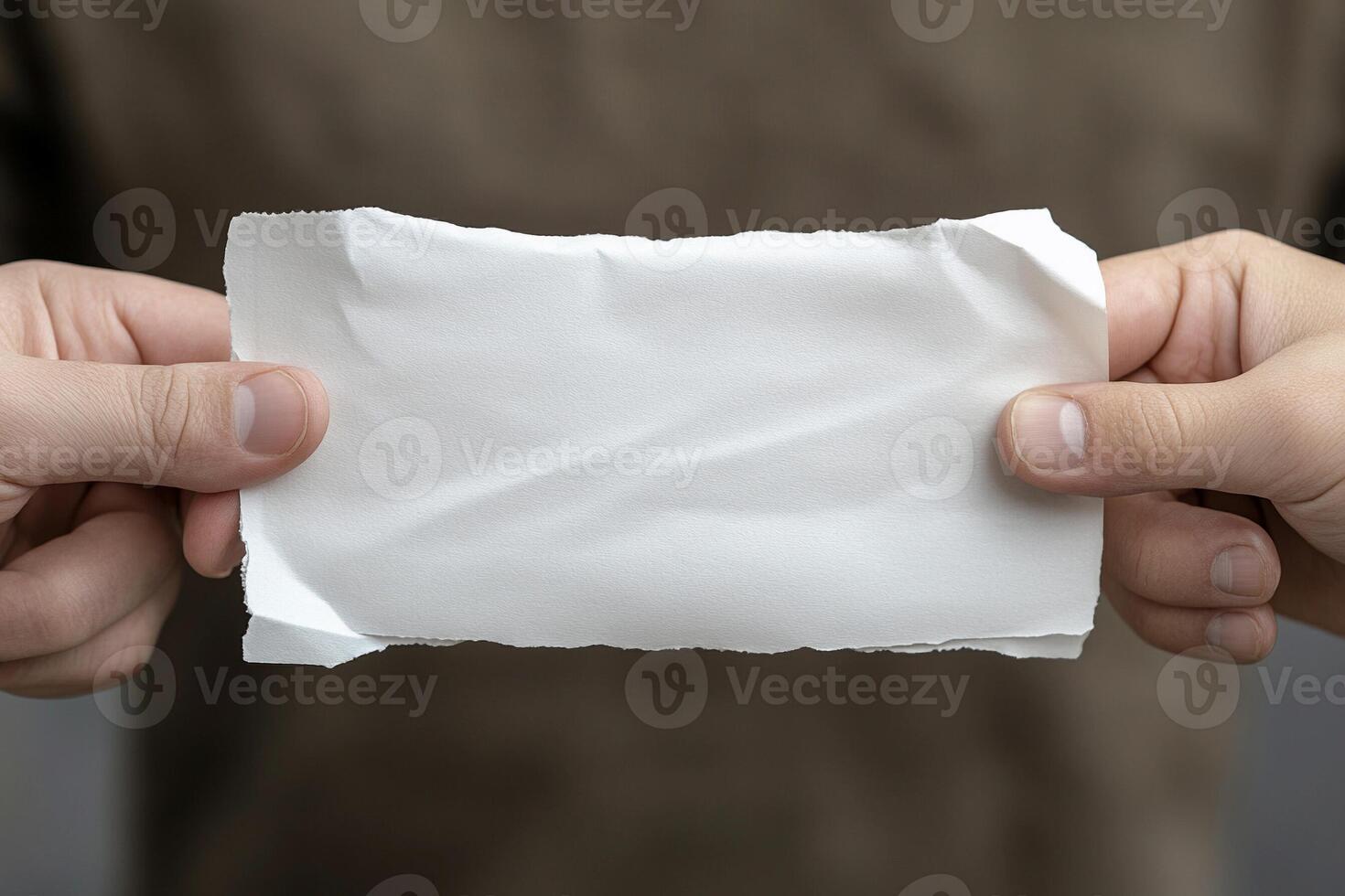 A person holding a piece of paper in their hands photo